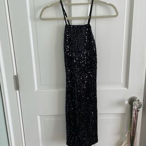 Black sequence mini dress with open back. Tag on